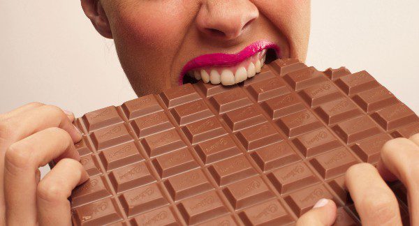 Lady eating chocolate bar